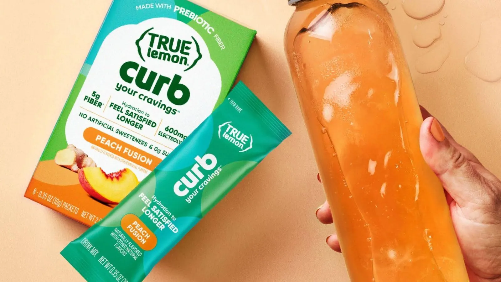 Hand Holding A Bottle Of Water Mixed With True Lemon Curb Peach Fusion