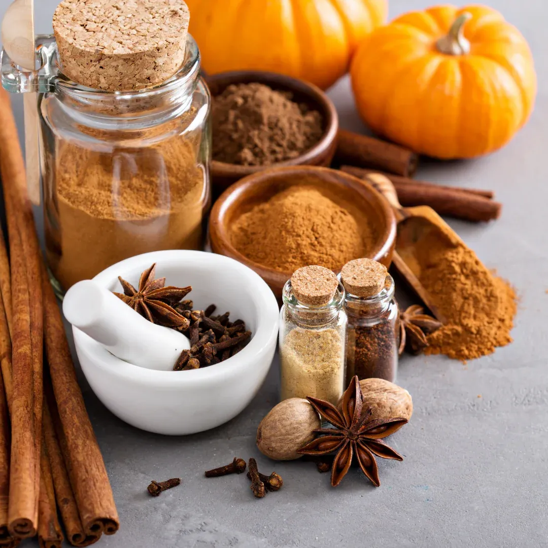An assortment of brown-colored spices including cinnamon and star anise.