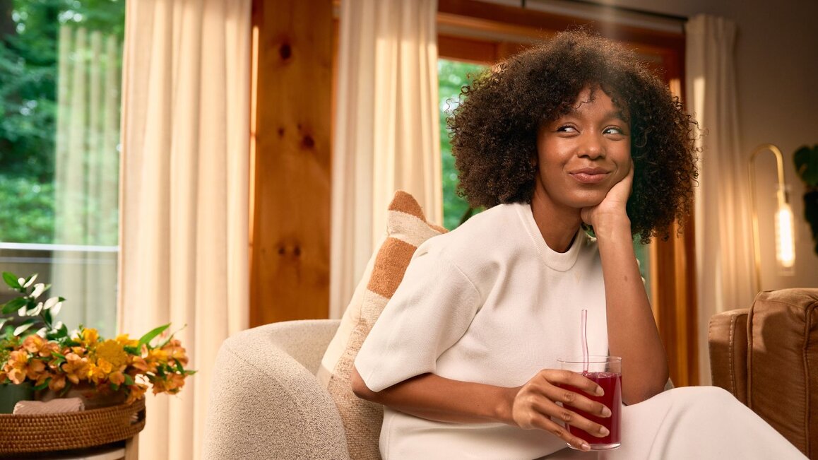 Woman Smiling And Drinking True Lemon Wildberry Lemonade