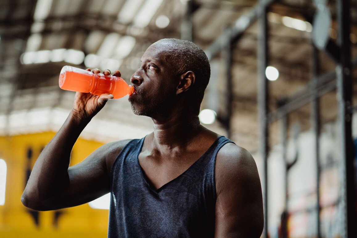 Man Drinking A Homemade Electrolyte Drink After Working Out