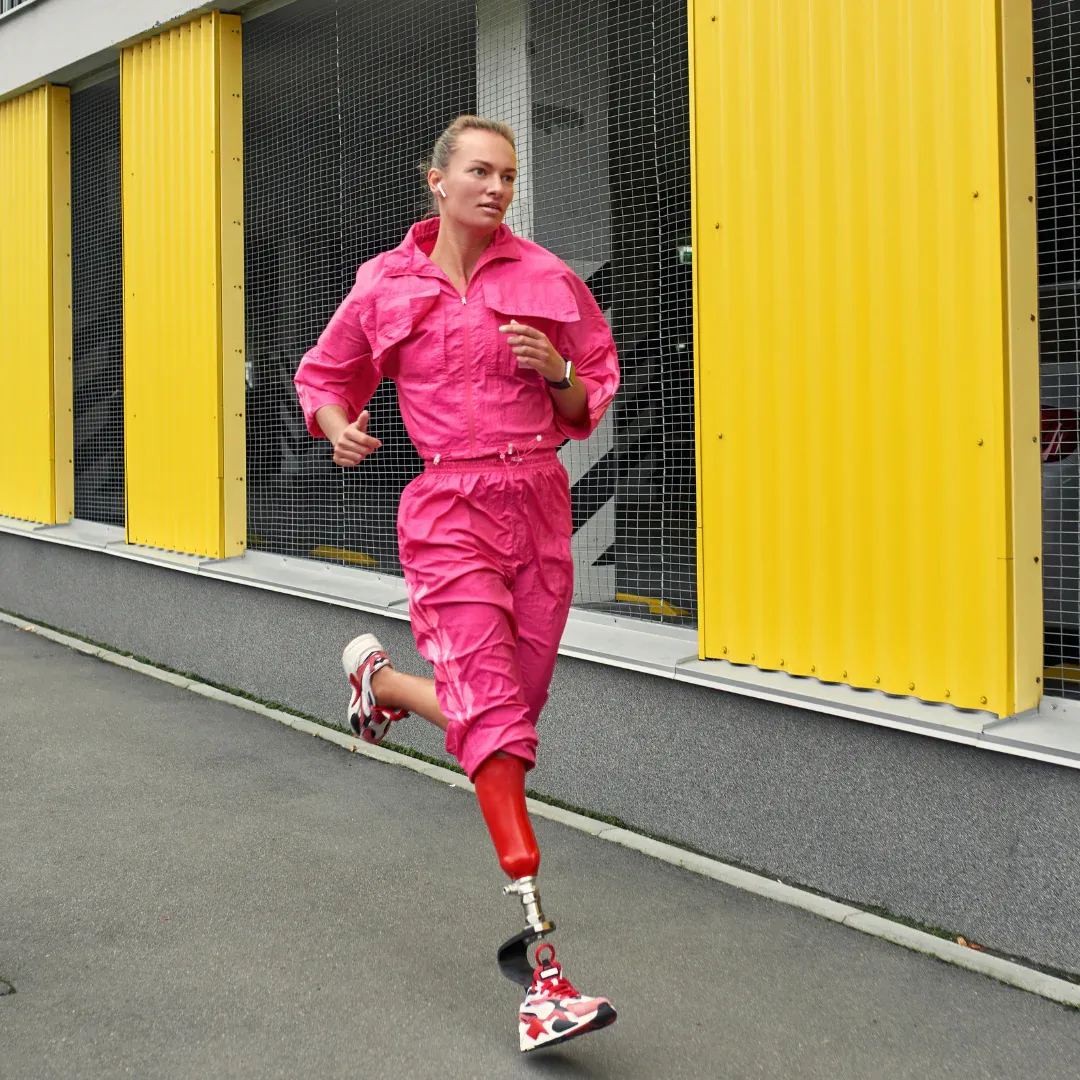 A woman in a pink jumpsuit is on a run.