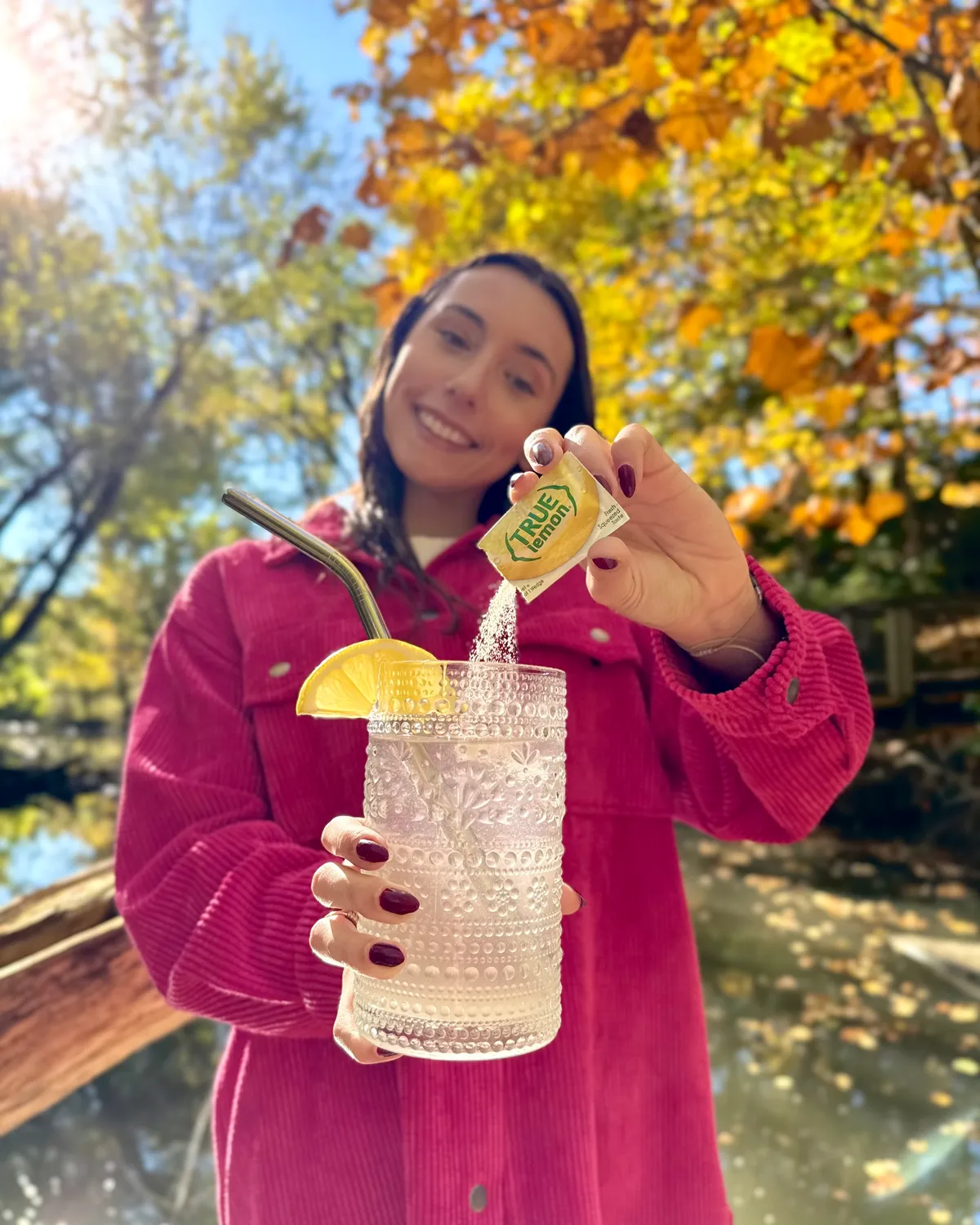 A man pours a packet of True Lemon into his water bottle.
