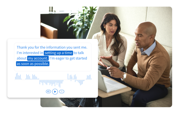 Businesswoman and businessman looking at something together on a laptop with overlay of the call sentiment