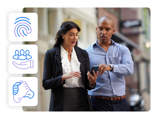 businesswoman and businessman looking at a smartphone together