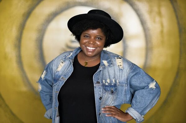 woman posing for camera smiling with her hands on her hips