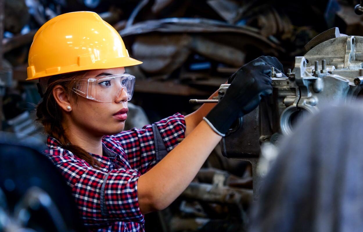 Construction worker who is a woman at work fixing an item