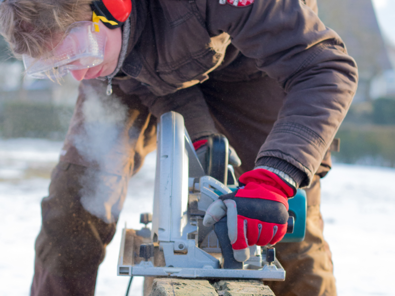 man outdoor working with a big circular saw
