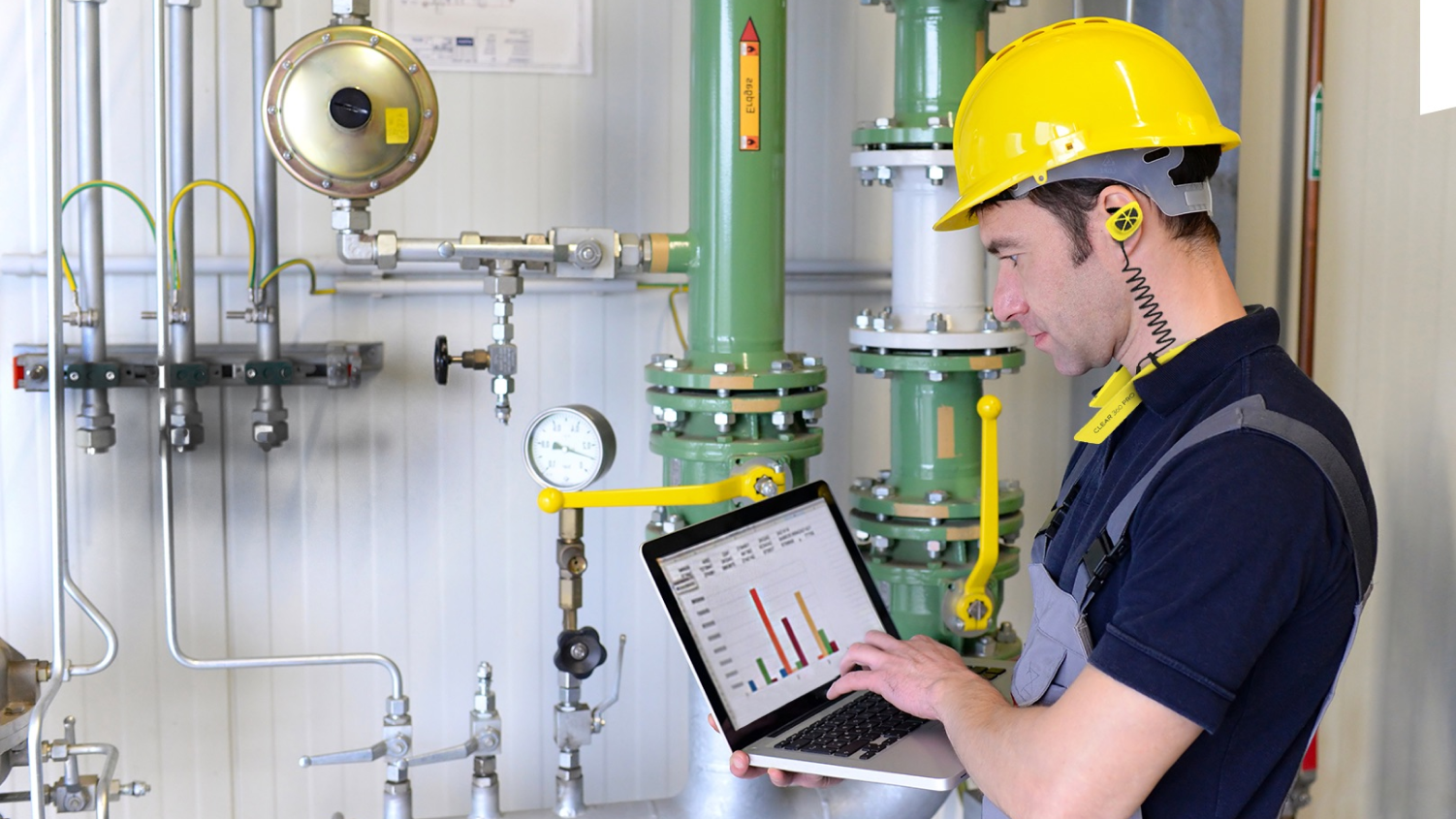 Male engineer wearing earplugs in factory