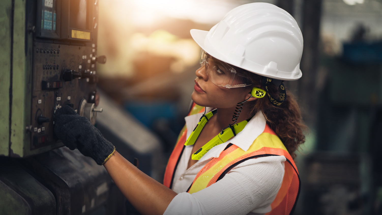 Female factory worker wearing earplugs