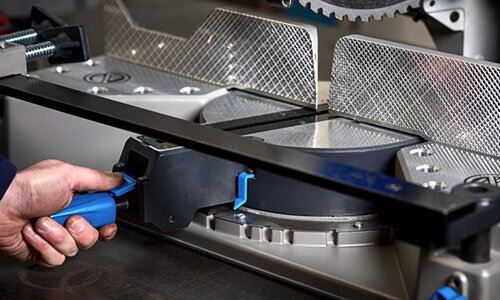 Picture demonstrating adjusting the mitering base on a chop saw.