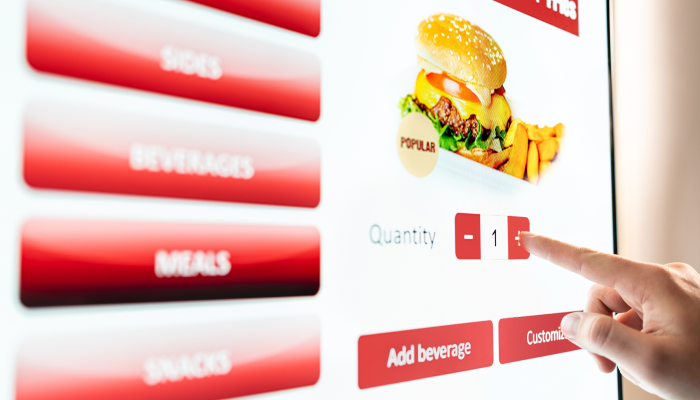 Image of a touchscreen displaying a menu and options to purchase food.