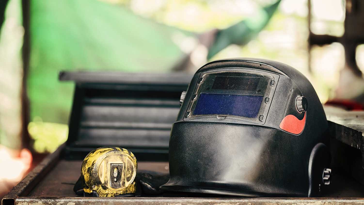 Image of a welding helmet laying on a flat surface.