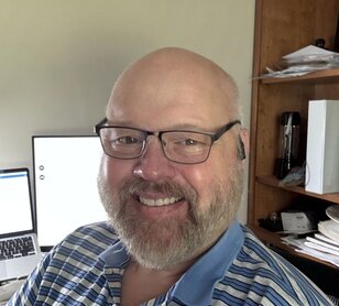 A 4Patriots 3-Month Survival Food Kit is placed outdoors near a growing garden.