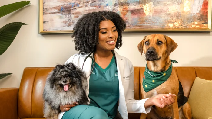 Dr. Aziza holding a small dog. 