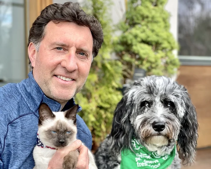 A photo of Scott Morris, Co-Founder & President of Freshpet, with his dog and cat.