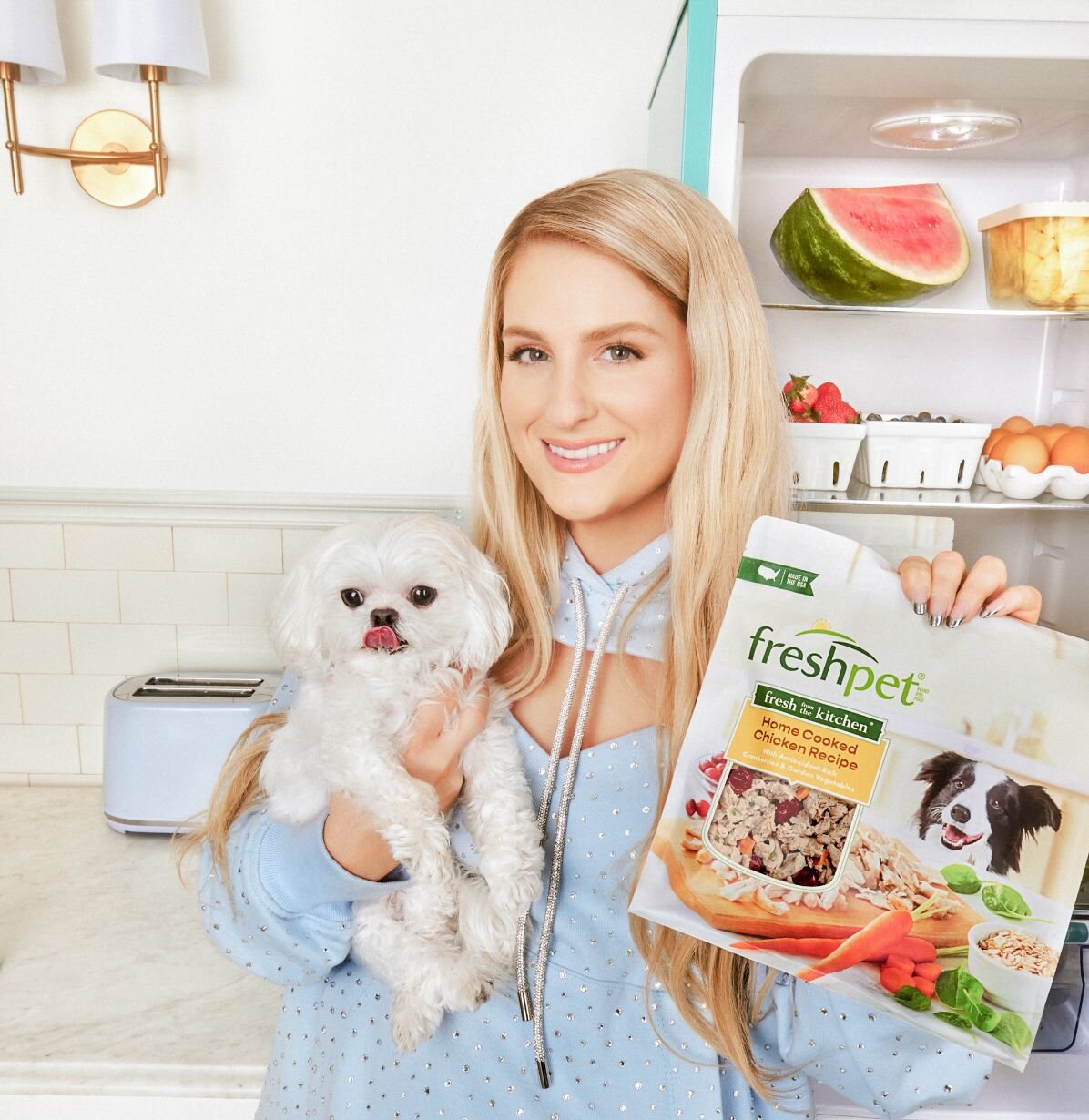 Meghan Trainor holding her dog and a bag of Freshpet Fresh From The Kitchen Chicken Recipe