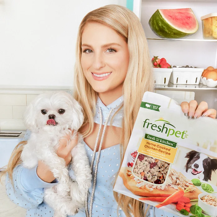 Meghan Trainor standing in a kitchen with her dog and a bag of Freshpet fresh dog food