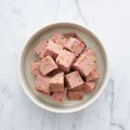Image of a bowl containing tasty pork recipe with peas and carrots