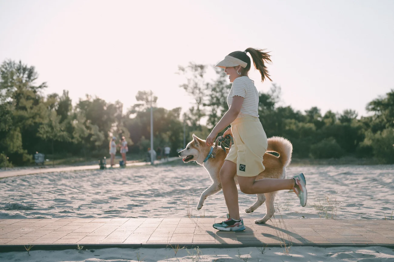 A woman on a run with her dog.