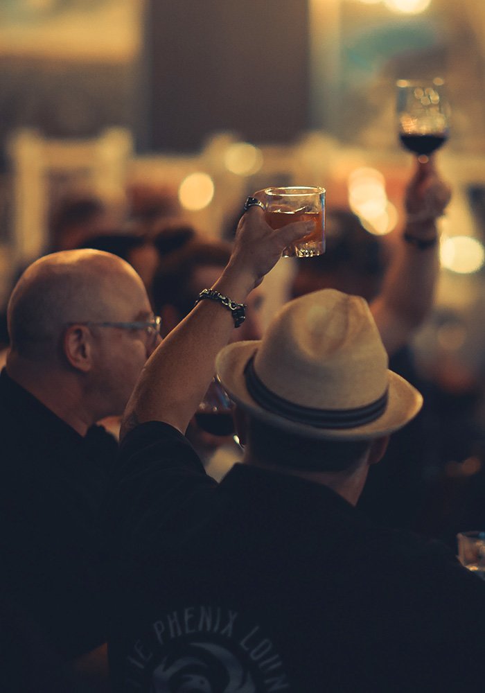 an image of two men holding up drinking glasses