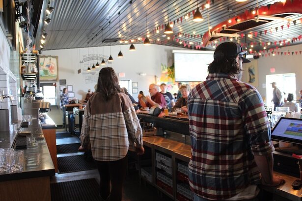 people serving at the AMB Mills River bar
