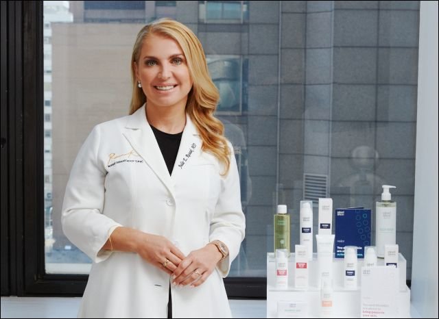 Board-Certified Dermatologist Dr. Julie Russak poses with Gladskin Eczema Collection