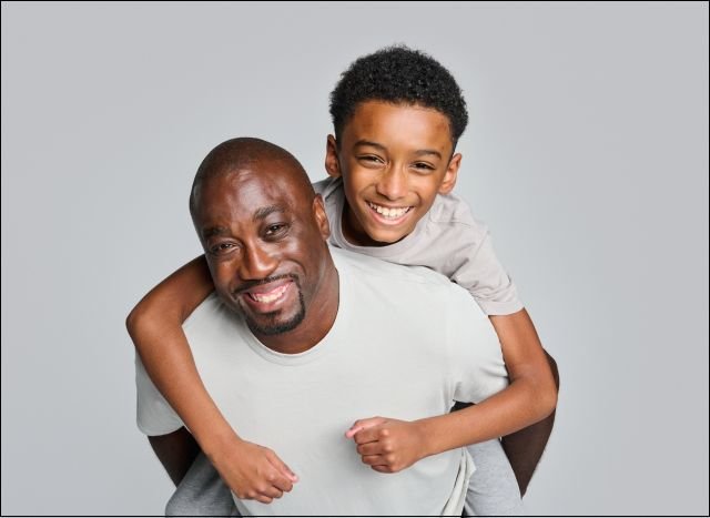 Father and son living with eczema smile