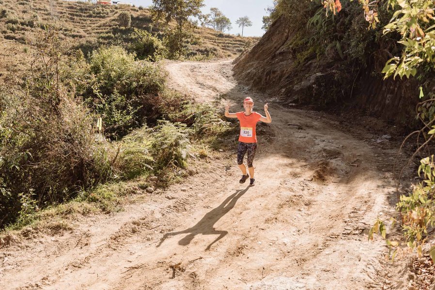 Woman running down the mountain trails.
