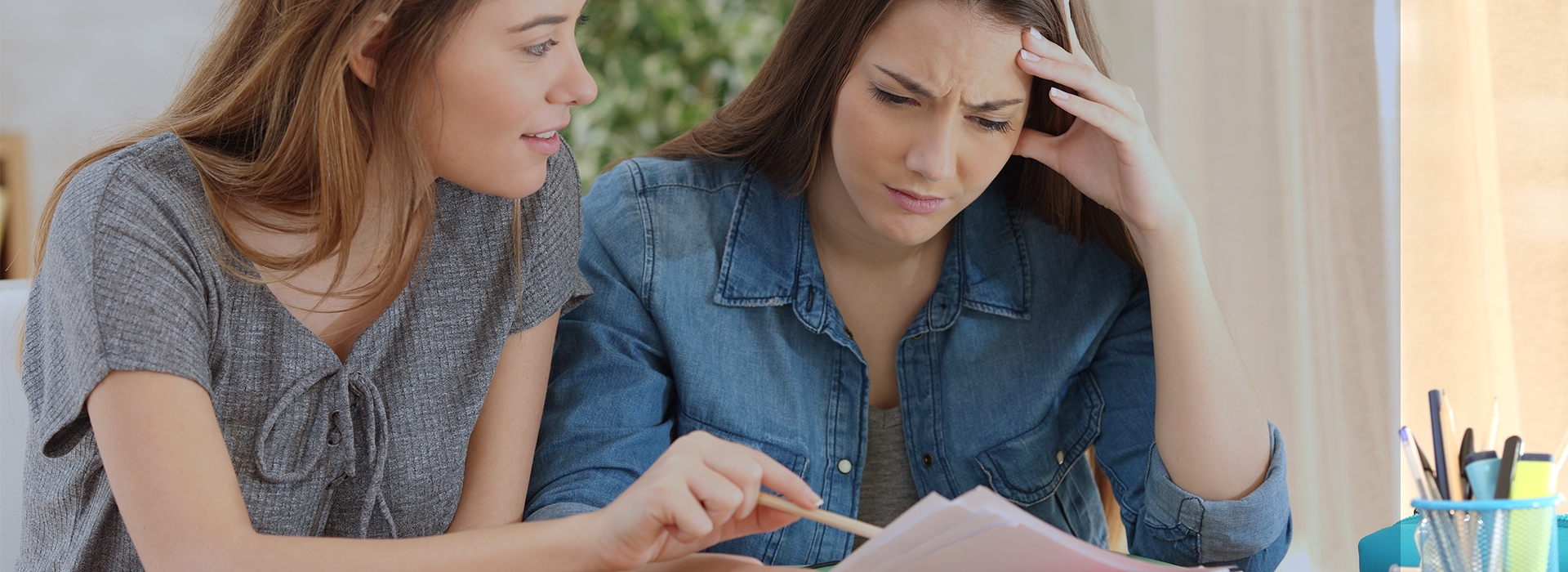 Two women looking at the paperwork