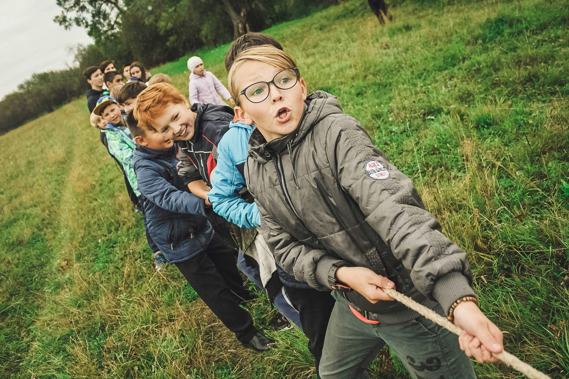 Boys pulling a tug of war rope