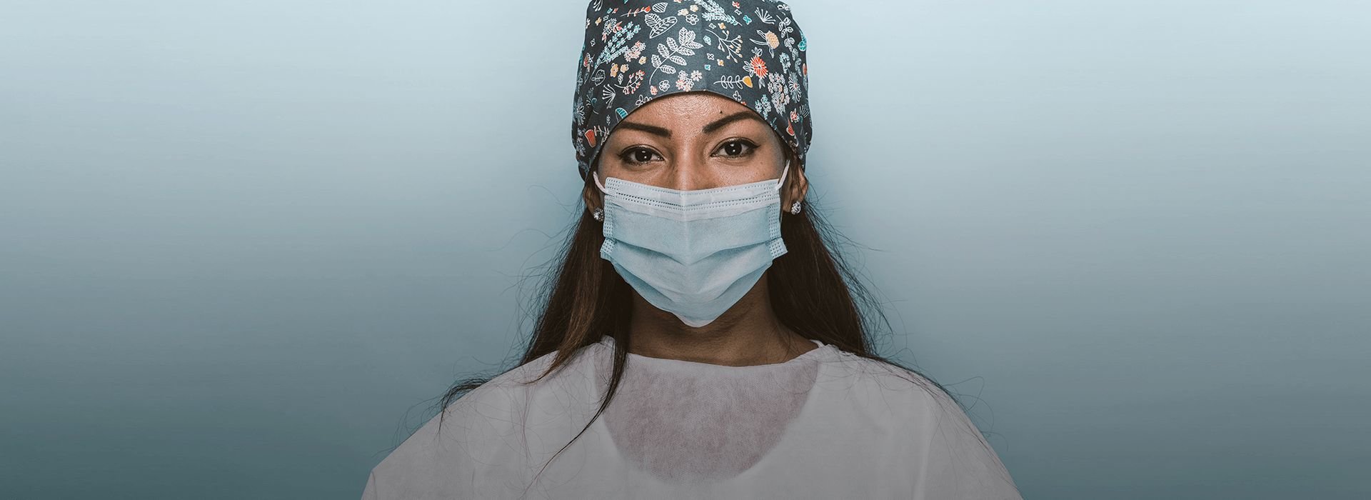 Woman in surgical hat and facemask