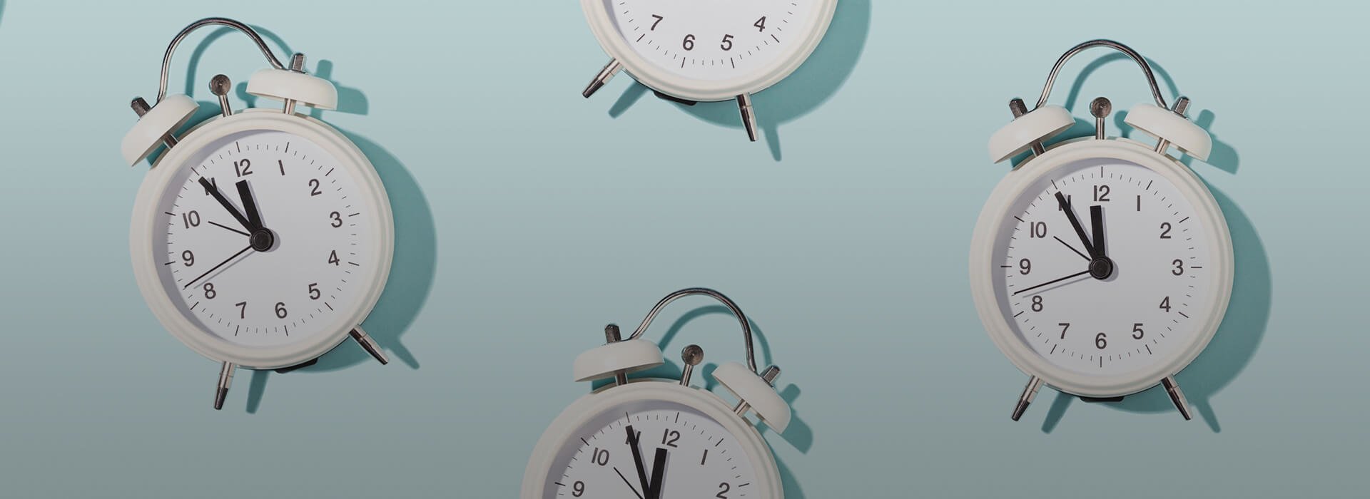 Four clocks hanging on a wall