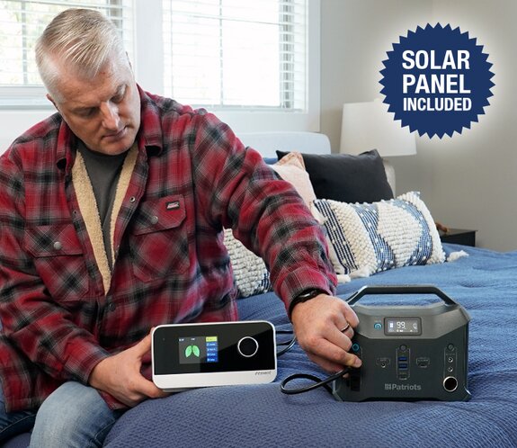 Man plugging in his CPAP machine into the Patriot Power Sidekick during a power outage 
