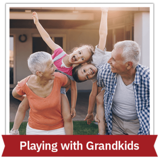 Older woman and man playing with two grandkids outside