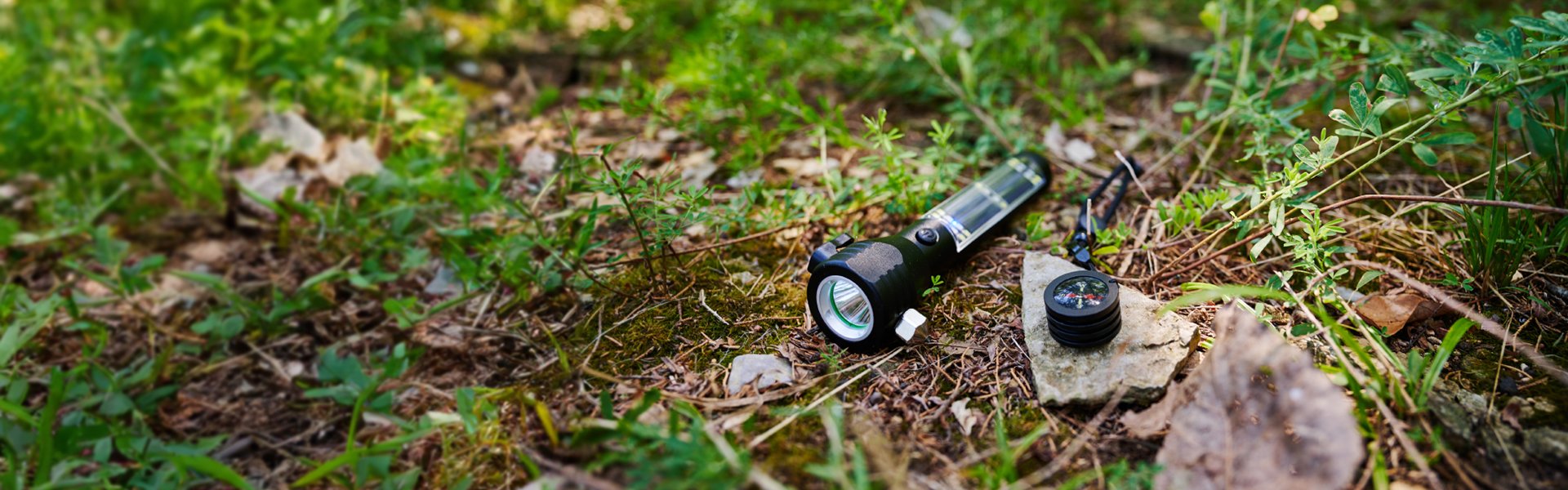HaloXT laying on the ground with the compass attachment sitting next to it on a rock