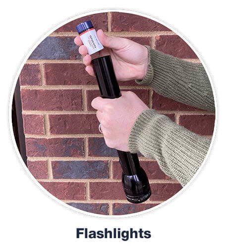 Hand placing 4Patriots battery flashlights