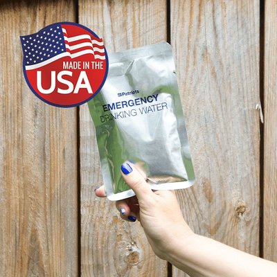 Hand holding up 4Patriots Emergency Drinking Water pouch. Made in the USA