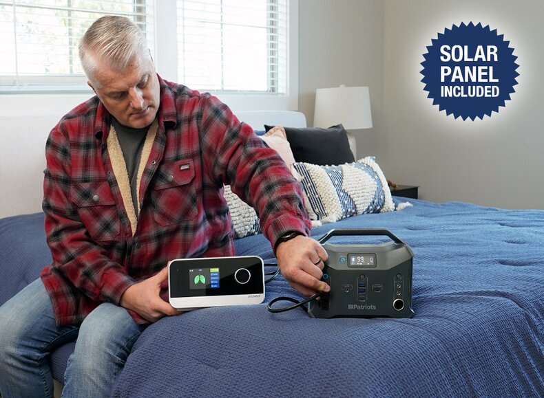 Man plugging in his CPAP machine into the Patriot Power Sidekick during a power outage 