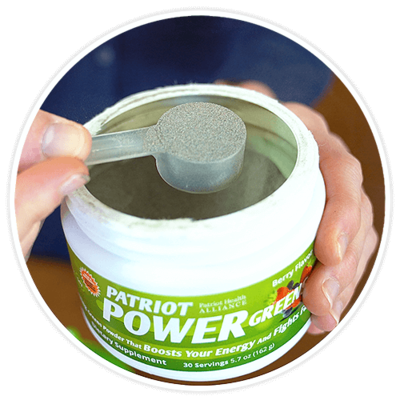 Hands scooping a serving of Patriot Power Greens from canister