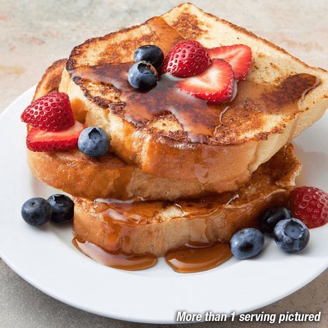 Stack of french toast on a plate with syrup and topped with strawberries and blueberries