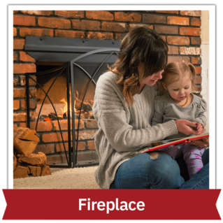 Woman and daughter reading a book inside next to a fireplace