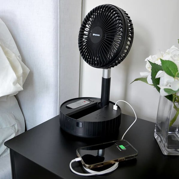 4Patriots Compact Rechargeable Fan charging a cell phone in its USB port