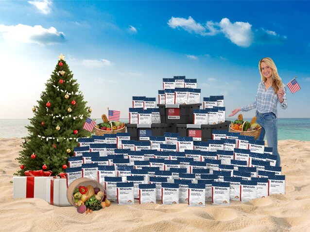 A woman standing on the beach with a Christmas tree
                  and a full stock of the 3-Month PlatinumXL food kit
                  celebrating 