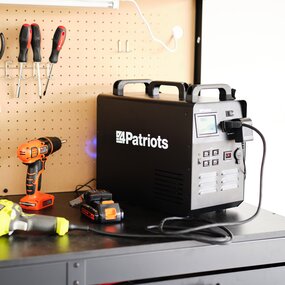 Patriot Power Solar Generator 1800 charges power tools in a garage.