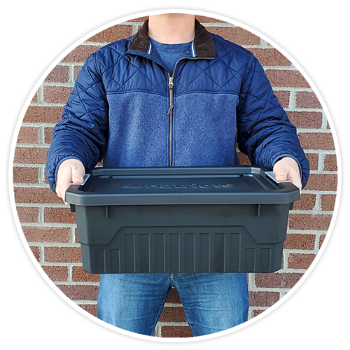Man holding small stackable storage tote.