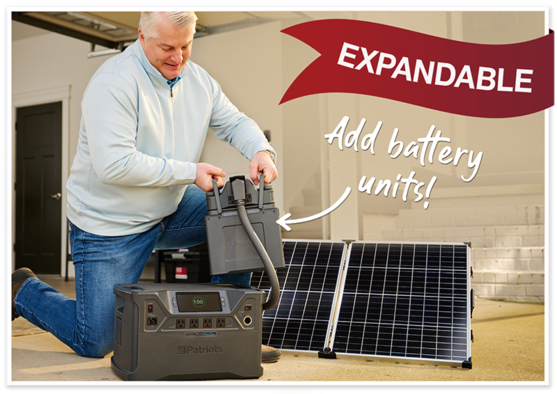 Man outside using the NEW Patriot Power Generator 2000X Power Station Expansion Pack attached to the Patriot Power Generator 2000X next to solar panel. Expandable and even more power!