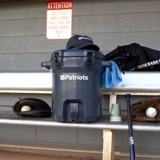 An Outdoor Water Filtration System sitting in the stands, ready to use at a baseball game.