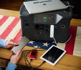Patriot Power Generator 2000X charging a laptop, 2 phones, and a tablet.