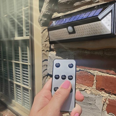 Someone using the remote to turn on the Solar Sentry Security Light