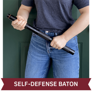 Person holding up the 4Patriots CoyoteXT All-in-1 Tactical Shovel Kit Self-Defense Baton.